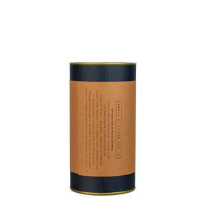 A navy blue cylinder with a brown label describes the roasted decaf coffee beans within.