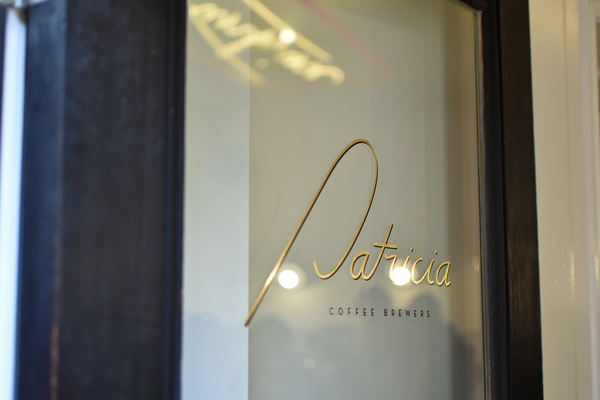 Patricia Coffee Brewers' front door with iconic logo in gold