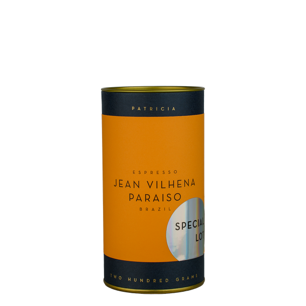 A navy blue cylinder with an orange label describes the roasted coffee beans within. 'PATRICIA' and 'TWO HUNDRED GRAMS' are printed in gold foil. A shiny round sticker reads 'SPECIAL LOT'