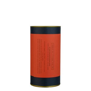 A navy blue cylinder with a red label describes the roasted coffee beans within.