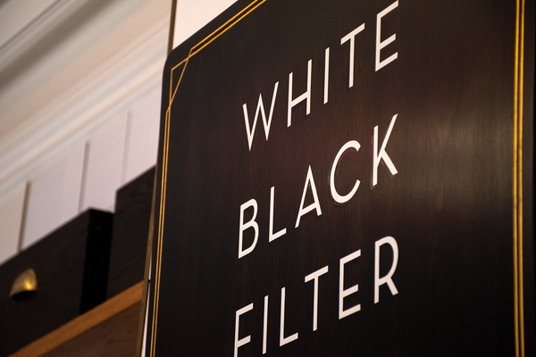 Close up of 'White, Black, Filter' on Patricia's giant wooden cafe menu.
