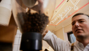 Specialty-coffee being ground in store for home espresso machine.