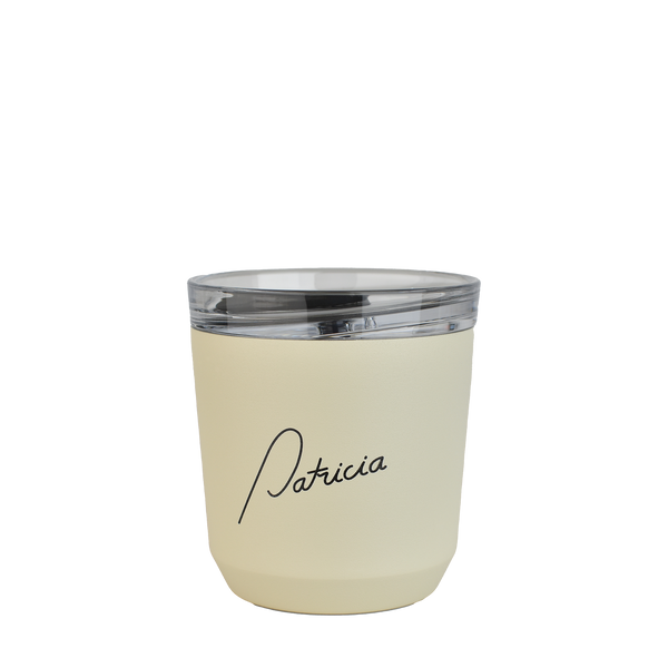 A cream coloured Kinto 240ml reusable coffee tumbler, with the Patricia logo printed in black on the front of it for your to-go coffee needs.