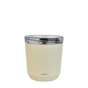 A cream coloured Kinto 240ml reusable coffee tumbler, from the back. It has Kinto printed small towards the bottom.