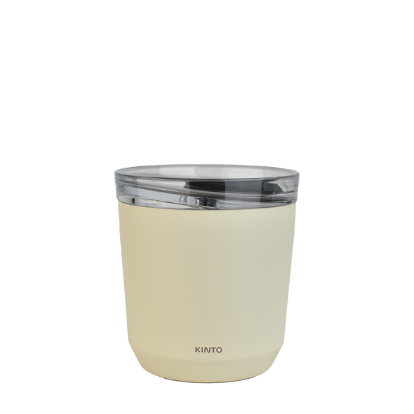 A cream coloured Kinto 240ml reusable coffee tumbler, from the back. It has Kinto printed small towards the bottom.