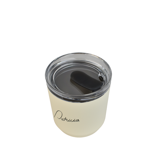 A cream coloured Kinto 240ml reusable coffee tumbler, viewed from above to show the clear plastic lid with silicon stopper in the open position. The Patricia logo printed in black on the front of it.