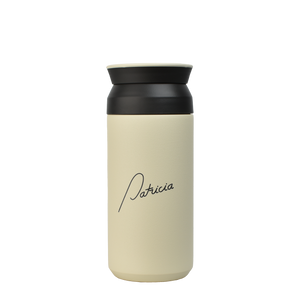 A cream coloured Kinto 350ml Tumbler with the Patricia logo printed in black on the front.