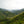 Lush green mountainous landscape with valleys under fog