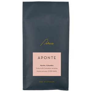 Navy blue recyclable coffee bag, with the Patricia logo in gold. It has a pink label that reads 'Aponte'.