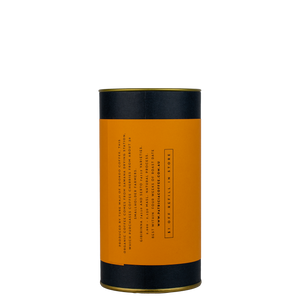 A navy blue cylinder with an orange label describes the filter coffee beans within.