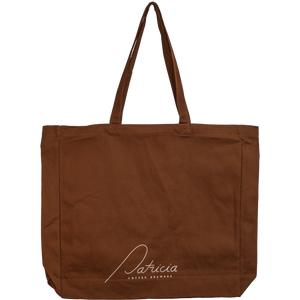 A brown canvas tote bag with long shoulder straps and a white script logo reading 'Patricia Coffee Brewers' on the lower front.