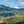Scenic view of green hills under a blue sky with clouds