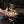 Hand catching coffee beans as they fall through a depulper