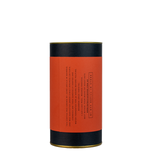 A navy blue cylinder with a colour label describes the roasted coffee beans within.