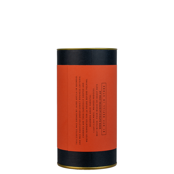 A navy blue cylinder with a colour label describes the roasted coffee beans within.