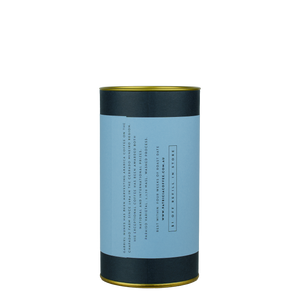 A navy blue cylinder with an red label describes the roasted coffee beans within.