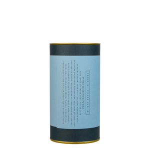 A navy blue cylinder with a blue label describes the roasted coffee beans within.