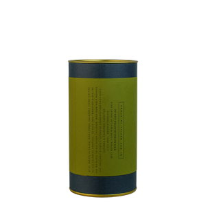 A navy blue cylinder with a green label describes the roasted coffee beans within.