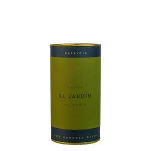A navy blue cylinder with a green label describes the roasted coffee beans within. 'PATRICIA' and 'TWO HUNDRED GRAMS' are printed in gold foil.