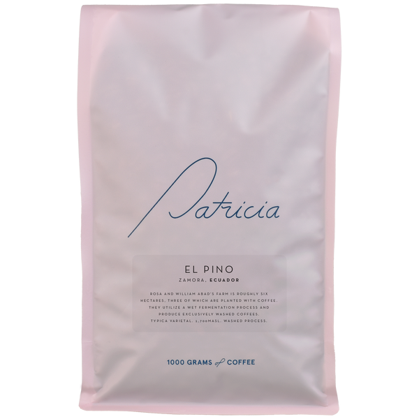 A light pink bag with the Patricia logo, containing 1kg of specialty coffee beans. 