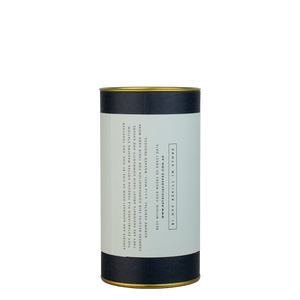 A navy blue cylinder with a light blue label describes the roasted coffee beans within.