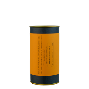 A navy blue cylinder with an orange label describes the roasted coffee beans within.