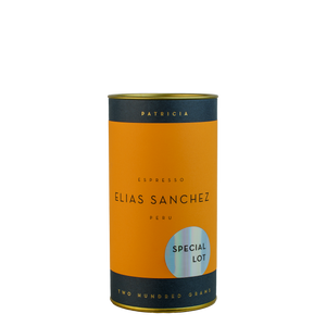 A navy blue cylinder with an orange label describes the roasted coffee beans within. 'PATRICIA' and 'TWO HUNDRED GRAMS' are printed in gold foil. A shiny round sticker reads 'SPECIAL LOT'