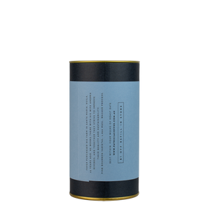 A navy blue cylinder with a blue label describes the roasted coffee beans within.