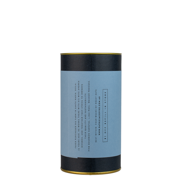 A navy blue cylinder with a blue label describes the roasted coffee beans within.