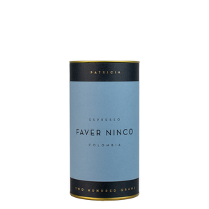 A navy blue cylinder with a blue label describes the roasted coffee beans within. 'PATRICIA' and 'TWO HUNDRED GRAMS' are printed in gold foil.