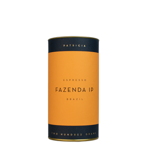 A navy blue cylinder with a orange label describes the espresso coffee beans within. 'PATRICIA' and 'TWO HUNDRED GRAMS' are printed in gold foil.