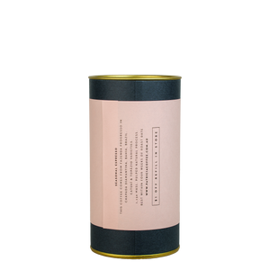 A navy blue cylinder with a pink label describes the espresso coffee beans within.