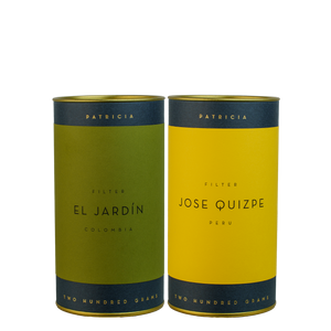 Two cylindrical filter coffee canisters side by side.
