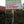 Signboard with text on a wooden post amongst coffee trees