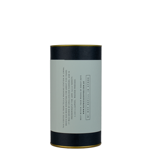 A navy blue cylinder with a light blue label describes the filter coffee beans within.