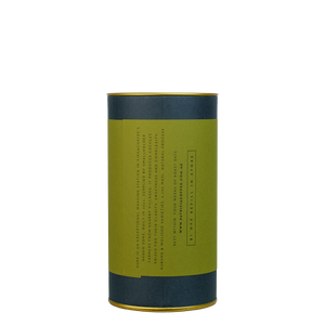 A navy blue cylinder with an green label describes the roasted coffee beans within.