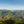 An amazing vista of Inza shows green mountains, with a large snow capped volcano in the distance.
