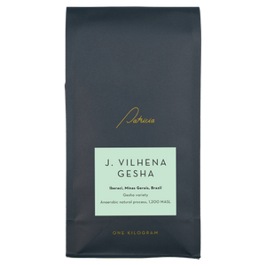 A navy blue recyclable bag containing 1kg of specialty coffee beans. It has the Patricia logo in gold, the coffee's name on a light blue sticker, and 'One kilogram' in gold underneath.