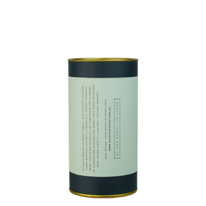 A navy blue cylinder with a light blue label describes the roasted coffee beans 