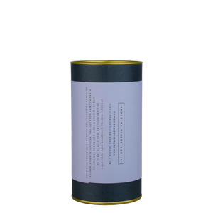 A navy blue cylinder with a purple label describes the roasted coffee beans within.