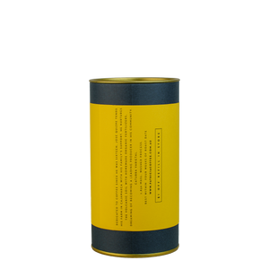 A navy blue cylinder with a yellow label describes the roasted coffee beans within.