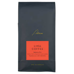 A navy blue recyclable bag containing 1kg of specialty coffee beans. It has the Patricia logo in gold, the coffee's name on a red sticker, and 'One kilogram' in gold underneath.