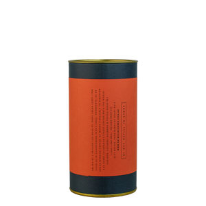 A navy blue cylinder with a red label describes the roasted coffee beans within.