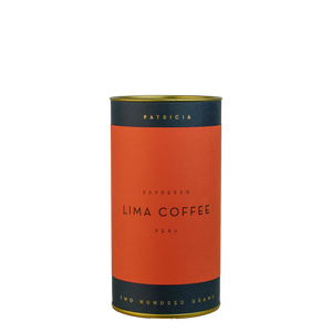 A navy blue cylinder with a red label describes the roasted coffee beans within. 'PATRICIA' and 'TWO HUNDRED GRAMS' are printed in gold foil.