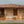 The Lomaverde homestead, with hanging plants and wooden railing.
