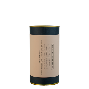 A navy blue cylinder with a pink label describes the espresso coffee beans within.