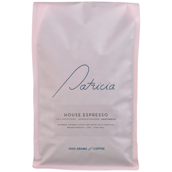 A light pink bag with the Patricia logo, containing 1kg of specialty coffee beans. 