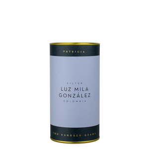 A navy blue cylinder with an lilac label describes the roasted coffee beans within. 'PATRICIA' and 'TWO HUNDRED GRAMS' are printed in gold foil.