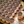 Person arranging 200g cylinders of House Espresso beans beans on a wooden surface