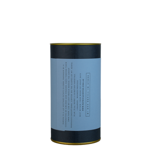 A navy blue cylinder with a blue label describes the roasted coffee beans within.